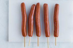 corn dog stick inserted into hot dog