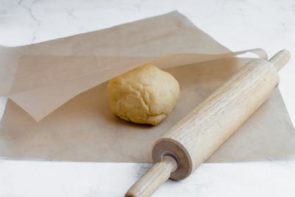 corn dog dough between parchment paper