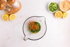 Seasoning in a clear, glass measuring cup.