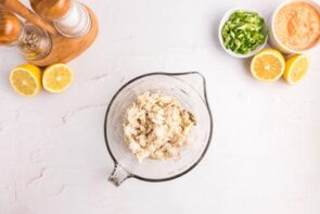 Lump crab meat sitting in a clear measuring cup.