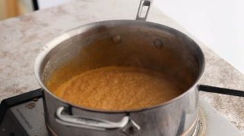 red curry sauce boiling on the stove top