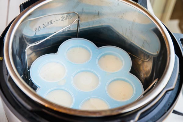 egg mixture in a silicone mold sitting inside the liner of an instant pot