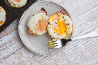 a fork cut into the yolk of an egg cup