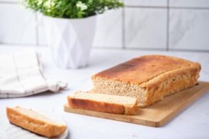 An egg loaf on a cutting board with a few slices cut off.