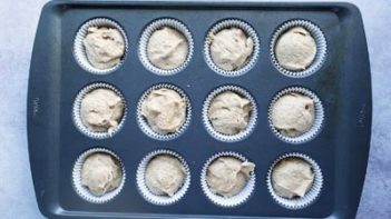 muffin batter in muffin liners of a pan