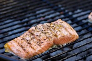 seasoned salmon grilling on a weber grill