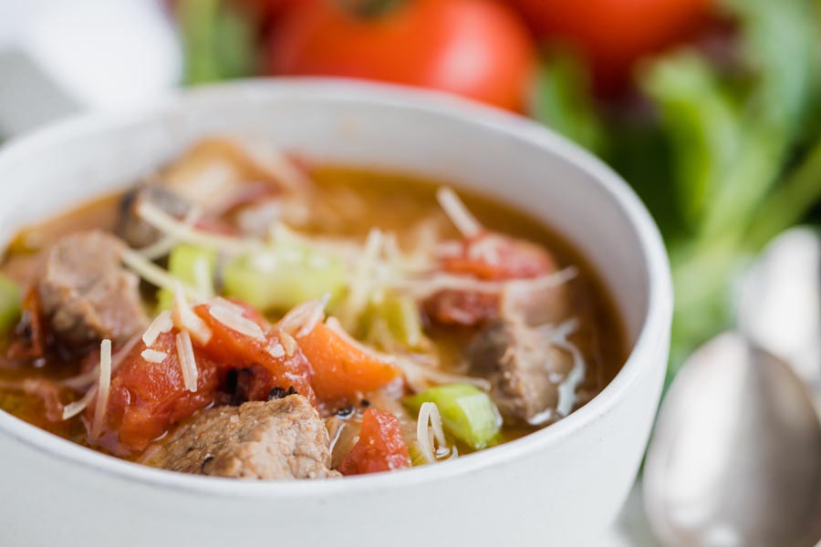 close up of a white bowl filled with beef stew