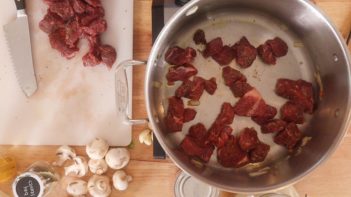 searing stew meat in a skillet