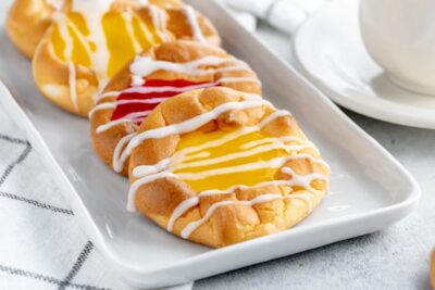 a plate with jelly danishes on a checkered towel