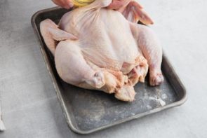 pouring chicken broth into the liner of an instant pot with the trivet insdie