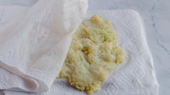 squeezing excess moisture off the cauliflower