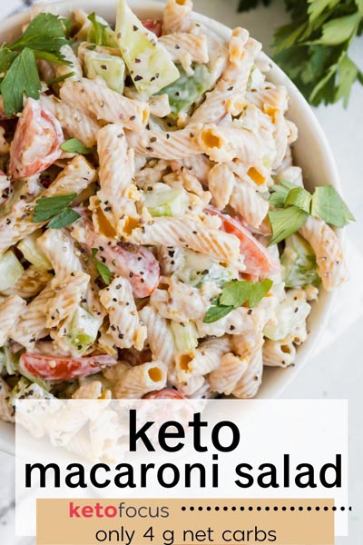 a pasta salad with tomatoes, parsley and green bell peppers