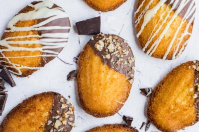 chocolate covered madeleines on a stone surface