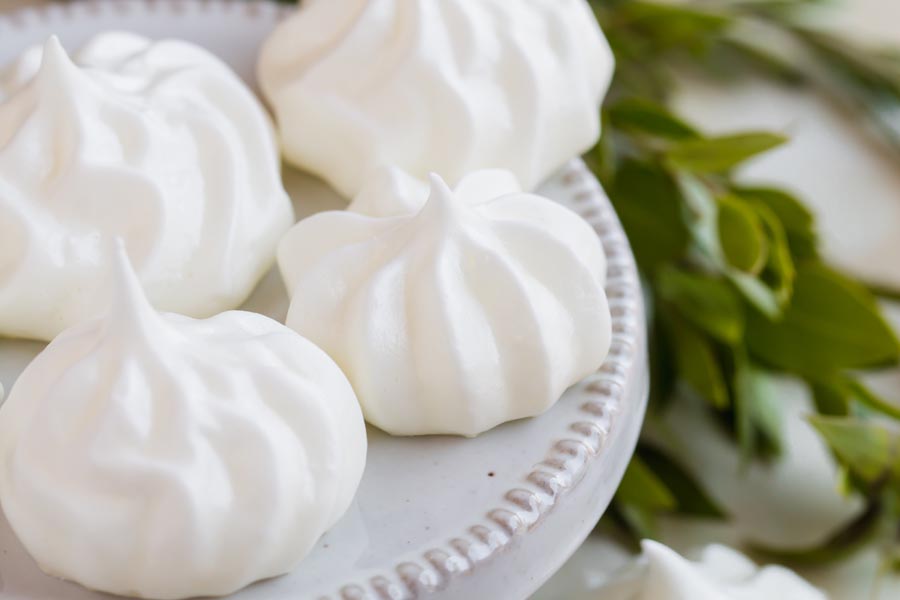 several white cookies on a plate