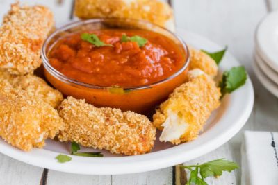 a plater of mozzarella cheese sticks and sprigs of parsley