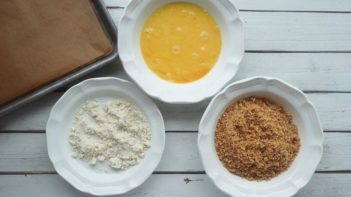 three bowls with almond flour, egg and ground pork rinds