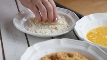 dusting mozzarella cheese in almond flour