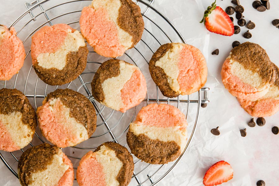 overhead shot of a bunch of neapolitan cookies cooling on a wire rack