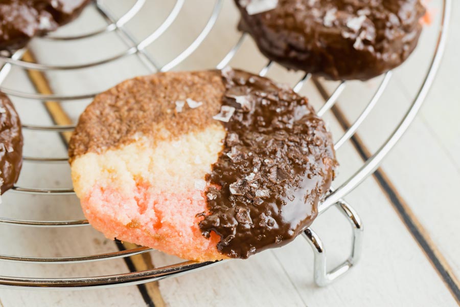 neapolitan cookie half dipped in dark chocolate and sprinkled with sea salt