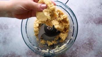 holding bread dough over a food processor