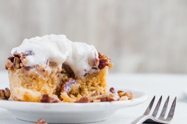 eating pecan pie mug cake with whipped cream