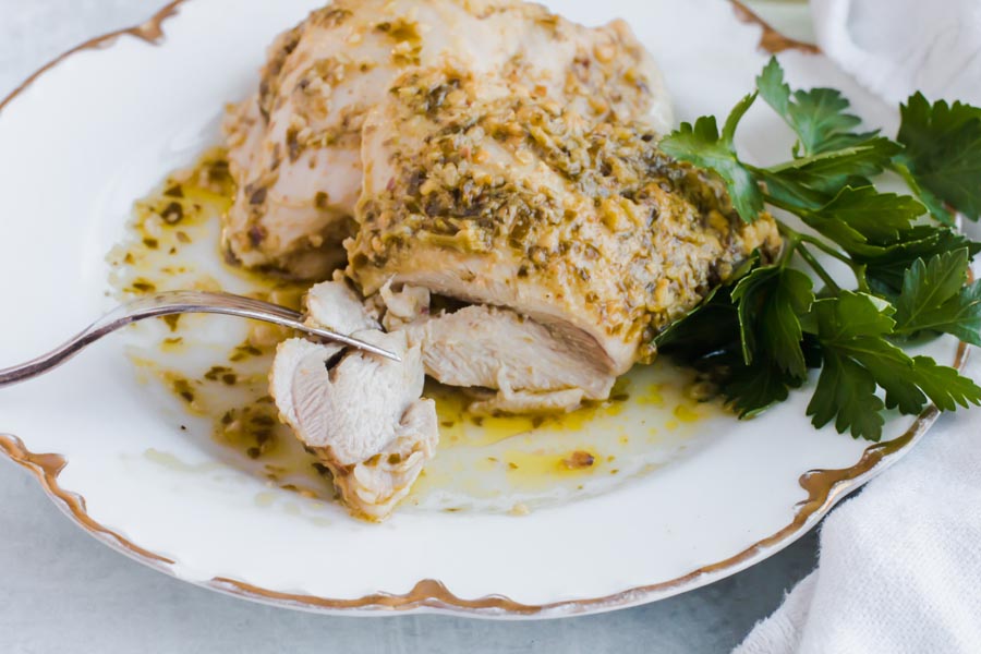 slicing into juicy low carb pesto chicken