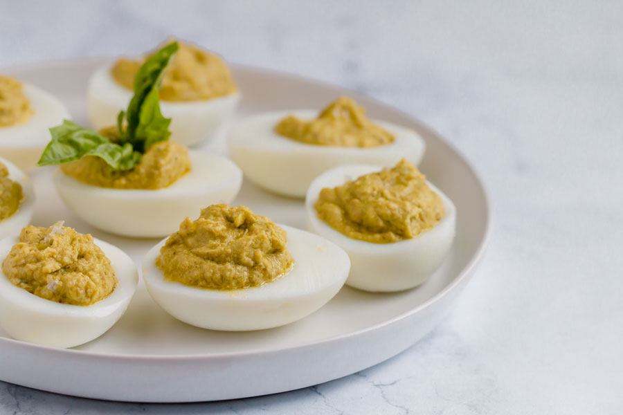 keto pesto deviled eggs on a circular plate