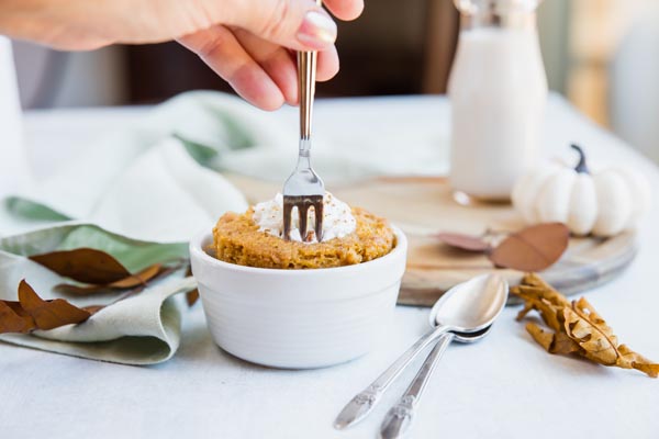 sinking a fork into a pumpkin cake