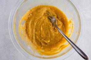 pumpkin cake batter mixed in a clear bowl