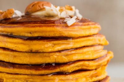 close up of syrup dripping from keto pumpkin pancakes