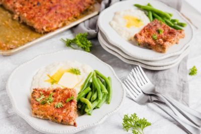 homecooked dinner of meatloaf and green beans on the table