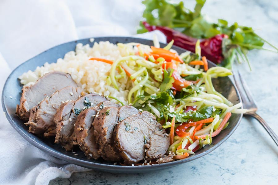 plate of keto marinated pork tenderloin with broccoli slaw