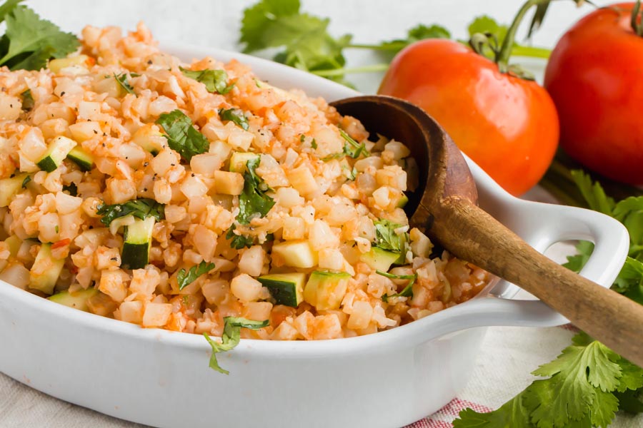 scooping out a serving of spanish cauliflower rice