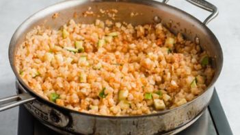 spanish cauliflower rice cooking in a pan