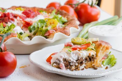 slice of keto taco pie with layers of beef