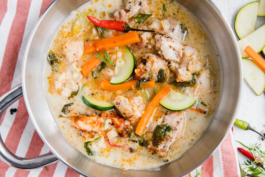 overhead shot of keto thai chicken soup with pieces of chicken