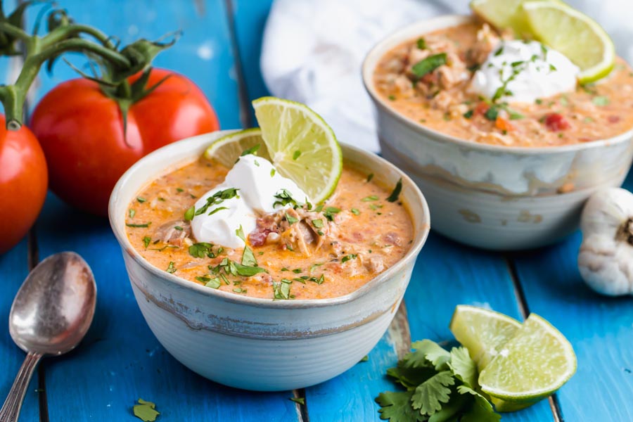 Bowls of beanless chili sitting on a blue table