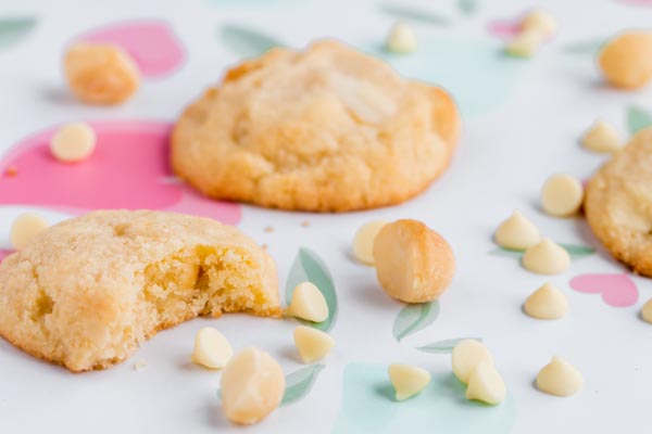 three cookies with one a bite out of and nuts around