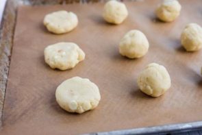 flatten cookie dough and cookie dough balls on a baking tray