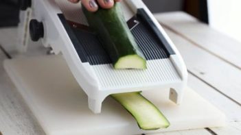 cutting sheets of zucchini with a madoline slicers