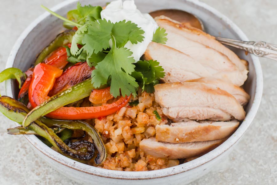 leftover rotissarie chicken in a spanish cauliflower rice bowl