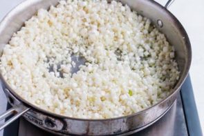 cauliflower rice cooking in a pan