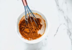 whisking pumpkin pie filling in a bowl