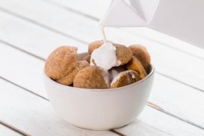 mini keto snickerdoodle cookie dough on a baking tray with parchment paper