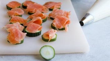 smoked salmon folded on top of slice cucumbers