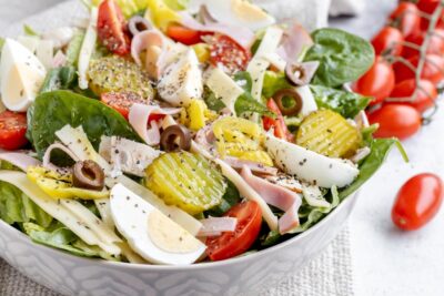 colorful salad in a bowl with egg, pickle and tomatoes