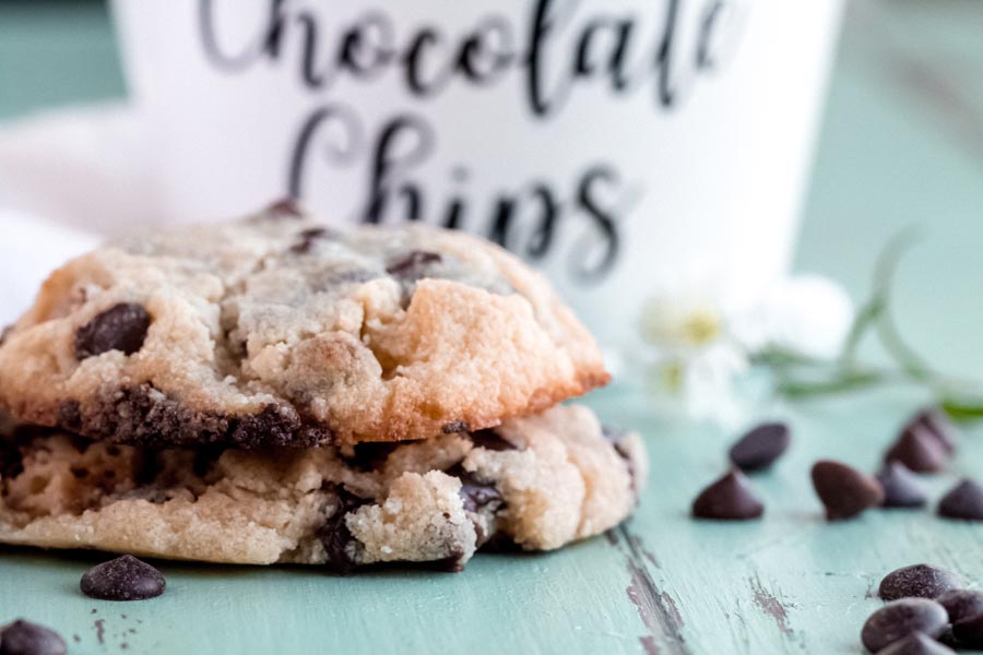 stack of low carb chocolate chip cookies with sugar free chocolate chips nearby