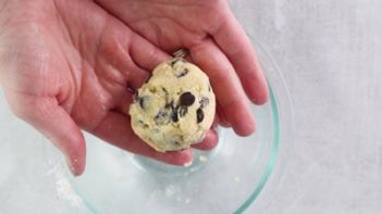 cookie dough ball in hands