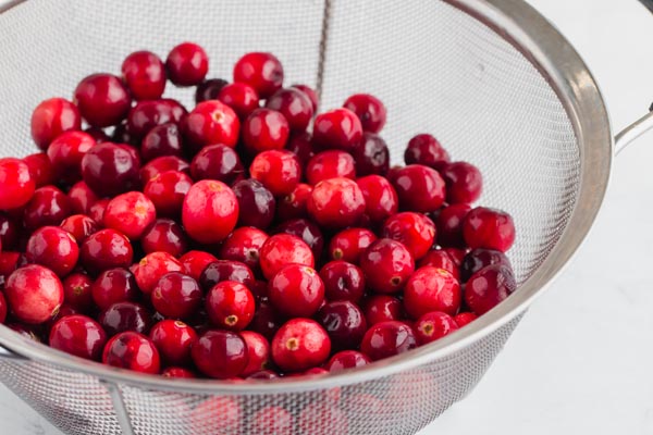 rinsing fresh cranberries in a colander